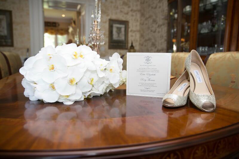 invitation with shoes and flowers