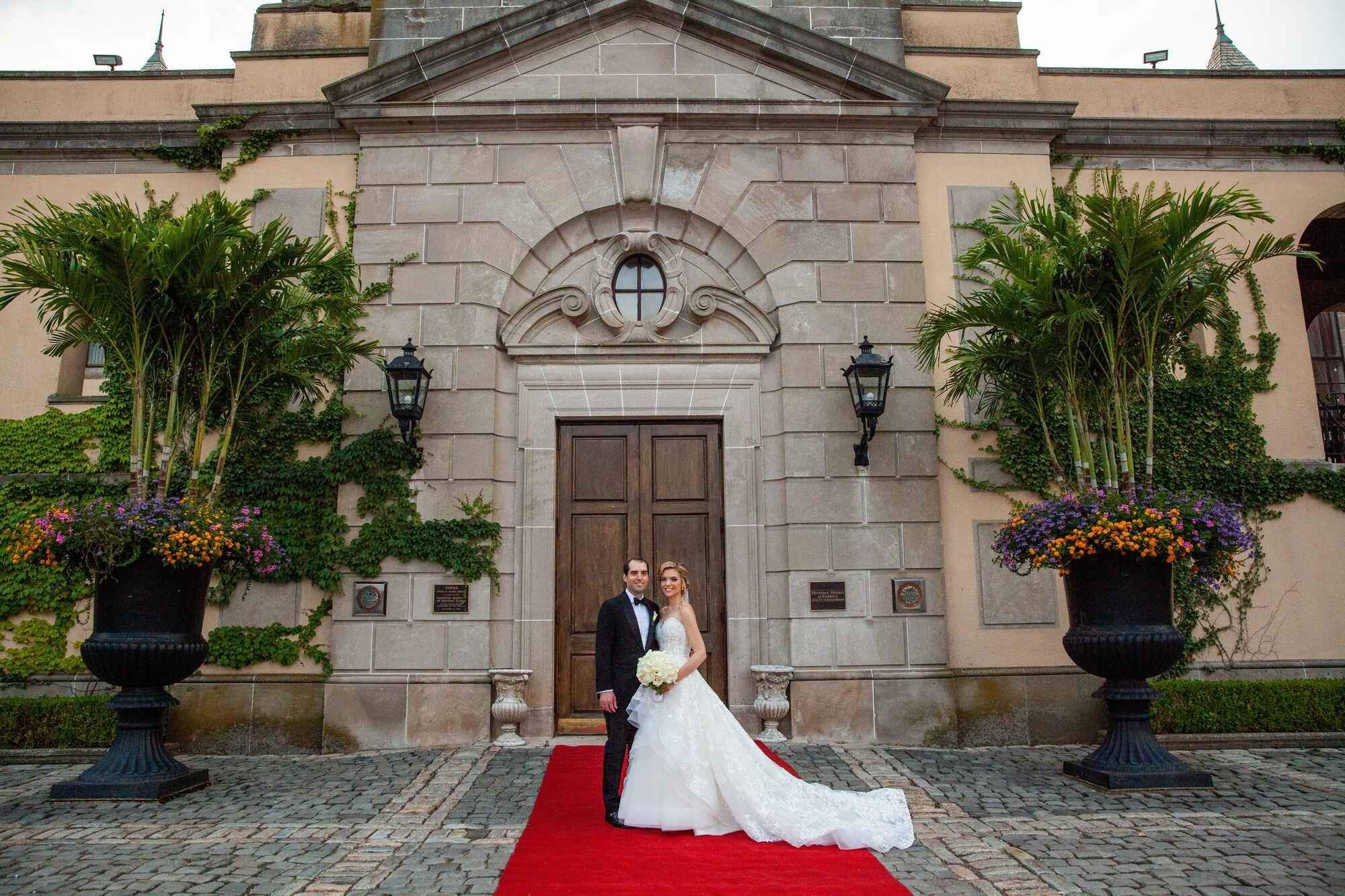 OHEKA CASTLE WEDDING BRIDE AND GROOM WITH RED CARPET