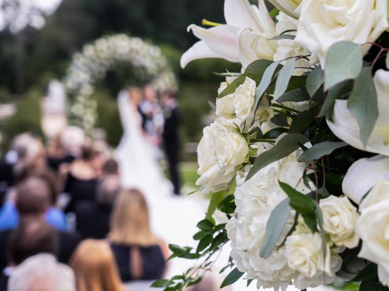 OHEKA CASTLE WEDDING FLORAL BRIDE IN GROOM IN BACKGROUND